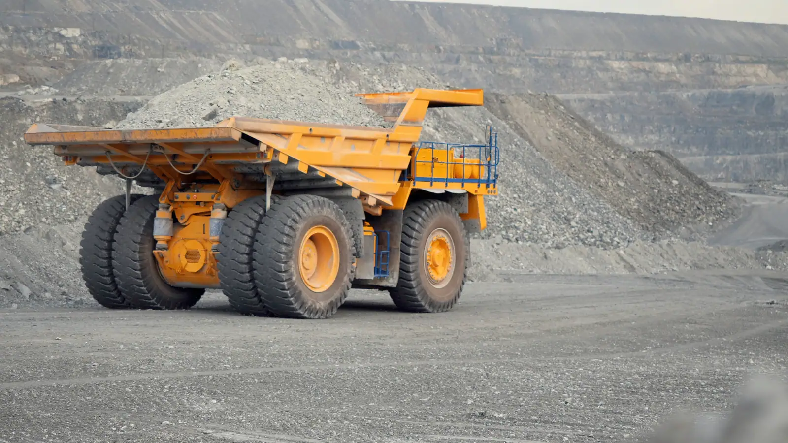 Rigid dump truck working a haul road at a Ghana mine